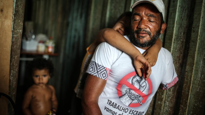 AÇAILÂNDIA, BRAZIL - APRIL 10: Former slave Miguel de Alexandre sits with his children at his house on April 10, 2015 in Açailândia, Maranhão state, Brazil.  (Photo by Mario Tama/Getty Images)