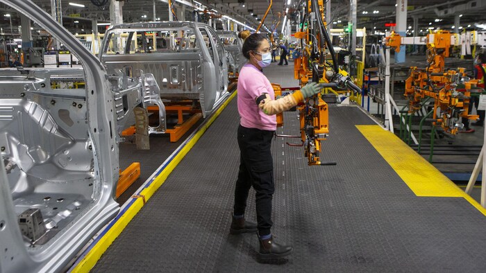 Employees assemble meat dishes for Chevrolet Silverados at GM in Oshawa.