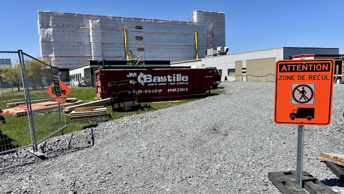 Une benne à ordures devant un chantier sur le site d'un centre hospitalier.