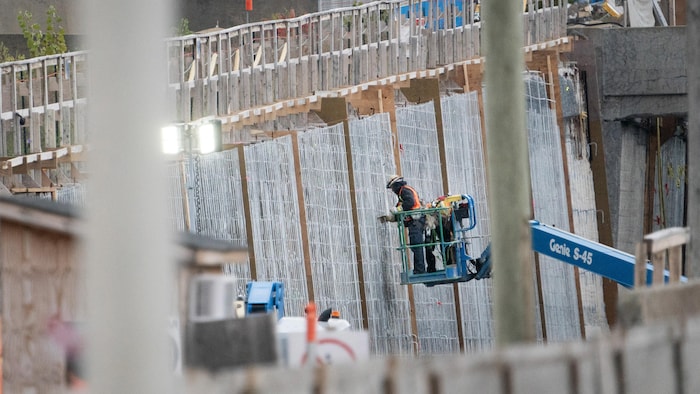 A worker in a basket near the Louis-Hippolyte La Fontaine Bridge tunnel.