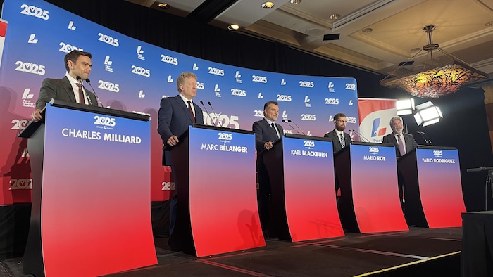 Les cinq candidats à la chefferie sont derrière un lutrin.