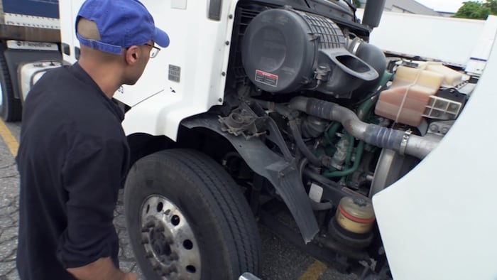 Ibrahim Manish practises inspecting a truck prior to a road test for his AZ licence.