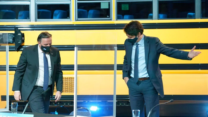 Prime Minister Justin Trudeau gestures to Quebec Premier Francois Legault as they leave a news conference in Montreal on Monday, March 15, 2021.