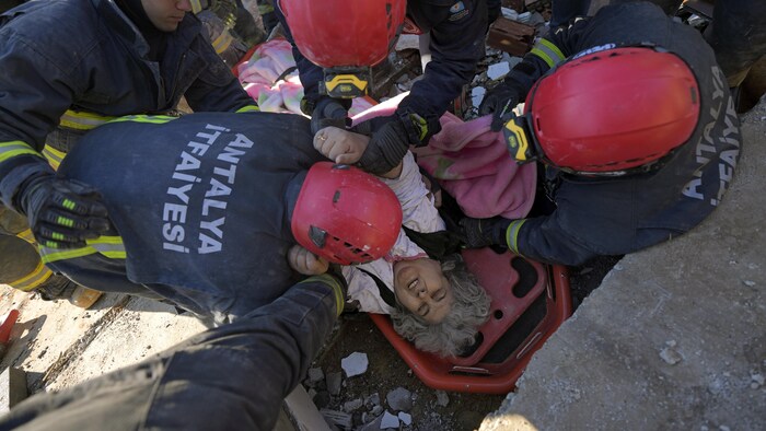 Rescue teams evacuate a survivor from the rubble of a destroyed building in Kahramanmaras, southern Turkey, on Tuesday. (Khalil Hamra/The Associated Press)