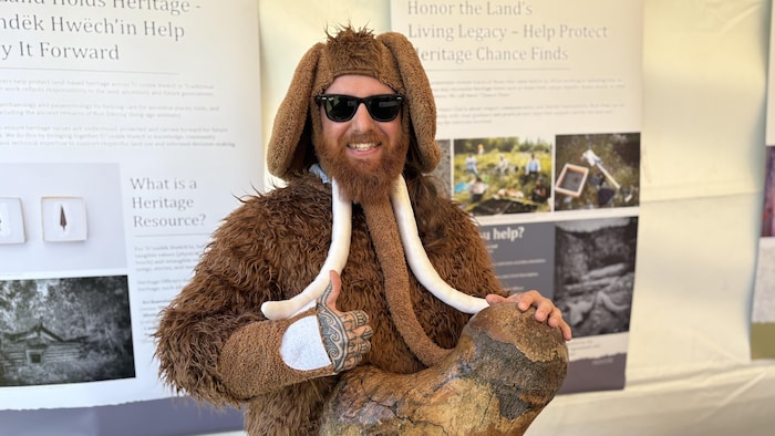 Un portrait de Ty Styner, souriant et vêtu d’un costume de mammouth.