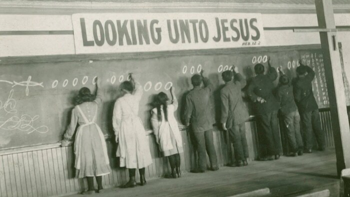 In this 1910s photo provided by the United Church of Canada Archives, students write on a chalkboard at the Red Deer Indian Industrial School in Alberta. In Canada, the National Truth and Reconciliation Commission identified 3,201 deaths amid poor conditions.