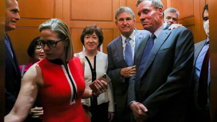 Two senators have been most responsible for watering down Biden's legislative plan: Kyrsten Sinema of Arizona, in the foreground, and Joe Manchin of West Virginia, in the background. (Evelyn Hockstein/Reuters)