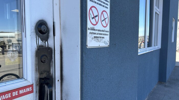 Une poignée peinte en noir sur une porte.