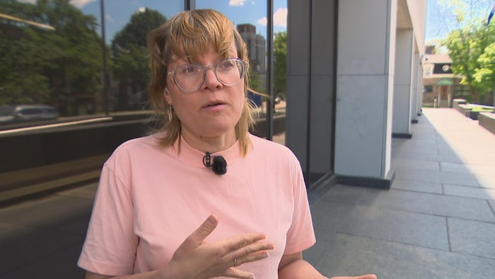 Véronique Laflamme en entrevue à l'extérieur d'un immeuble.
