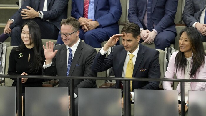 Michael Kovrig and Michael Spavor stand as they are recognized before President Joe Biden speaks to Parliament in Ottawa on March 24, 2023.