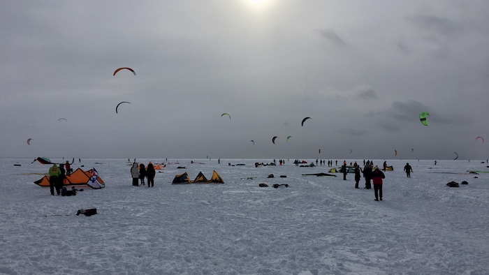 Des gens font des sports de voile d'hiver.