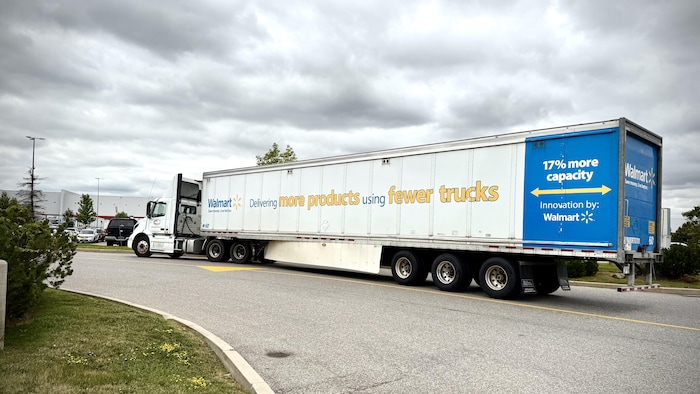 Un camion de marchandises de Walmart entre dans le stationnement d'un entrepôt.