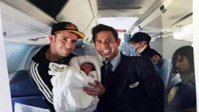A photograph of birth father Wesley Branch holding newborn Chloe next to a flight attendant onboard the Air Canada plane she was born in on May 10, 2015. Japanese citizens donated baby clothes and other items after the story generated significant coverage.
