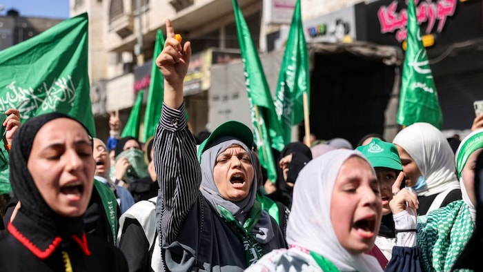 Women chant slogans while marching in a rally organized by supporters of the Fatah and Hamas movements in solidarity with Gaza, in the city of Hebron in the occupied West Bank, on Friday. (Hazem Bader/AFP/Getty Images)