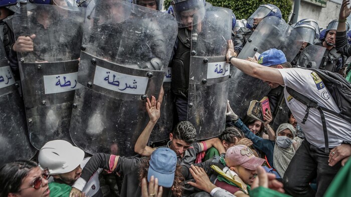 Des étudiants se bagarrent avec la police antiémeute durant une manifestation contre le gouvernement à Alger. 