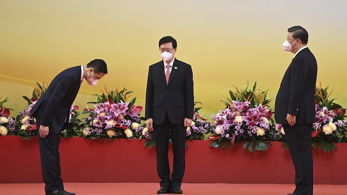 Hong Kong's new Secretary for Innovation, Technology and Industry Sun Dong, left, bows as China's President Xi Jinping, right, and Hong Kong's new Chief Executive John Lee, left, look on, during a ceremony to inaugurate the city's new government in Hong Kong Friday, July 1, 2022, on the 25th anniversary of the city's handover from Britain to China. (Selim Chtayti/Pool Photo via AP)