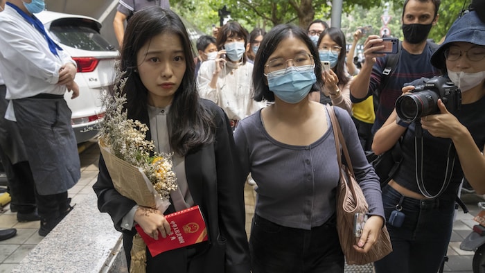 Zhou Xiaoxuan, left, a former intern at China's state broadcaster CCTV, arrives to attend a court session at a courthouse in Beijing, Tuesday, Sept. 14, 2021. Zhou became the face of the country's MeToo movement after going public with accusations against a prominent CCTV host in 2018. Since then, even as the movement was shut down by authorities, Zhou has continued to speak out. (AP Photo/Mark Schiefelbein)