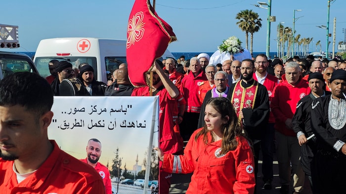 Rescuers mourning the death of their colleague Youssef Assaf, killed in an Israeli strike in Tyr.