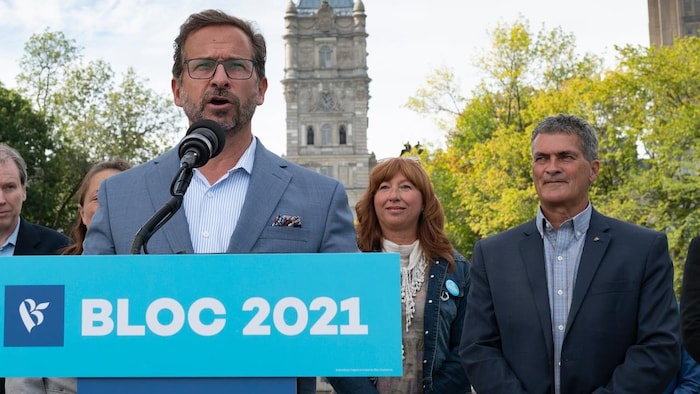 Bloc Québécois Leader Yves-Francois Blanchet during a news conference Sept. 18, with candidate Louis Sansfacon in Quebec City. The leader is standing in front of microphone.