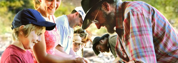 Adults and children examining bowls