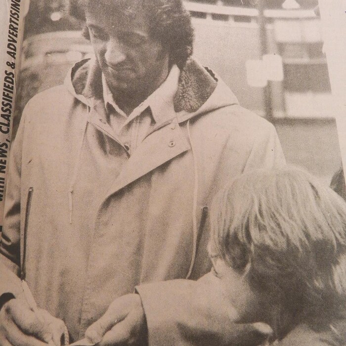 L'acteur Sylvester Stallone signe un autographe à un jeune admirateur.