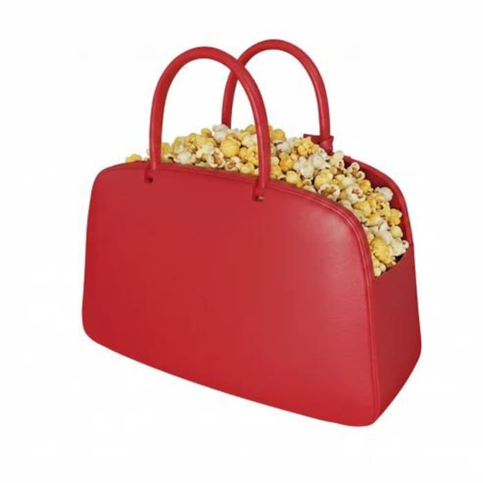Un sac rouge en plastique est rempli de maïs soufflé.