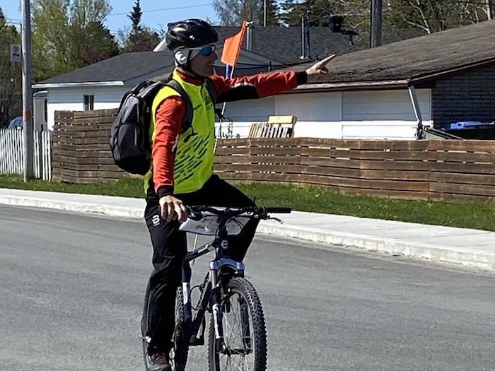 Un instructeur à vélo pointe dans une direction.