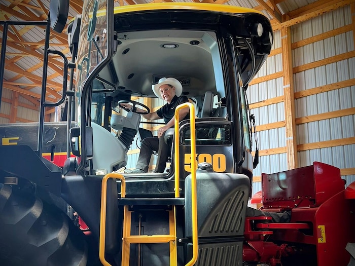 Tony Loffreda est assis sur le siège d'un tracteur.