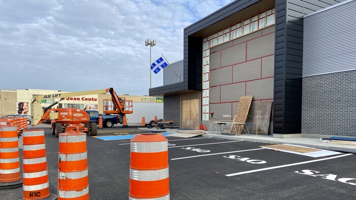 Des cônes orange autour d'une succursale de la SAQ en construction.