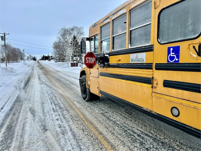 Un autobus scolaire, en mouvement, durant l'hiver.