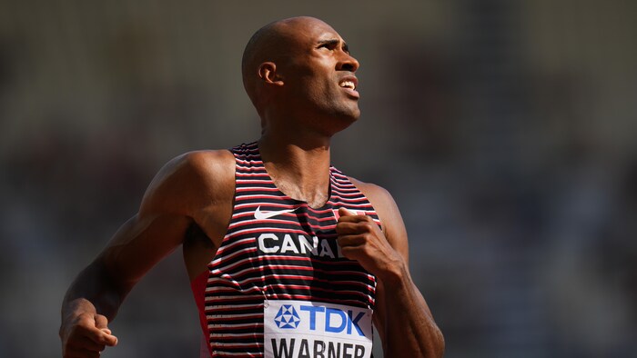 Un athlète regarde au loin après sa course.