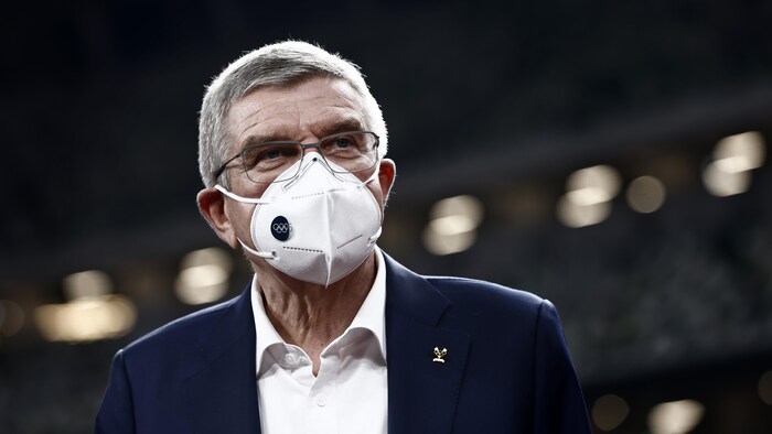 Thomas Bach porte un masque.