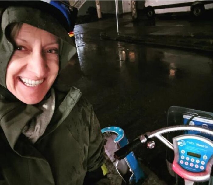 Allison Boulton on a Mobi bike on a rainy night.