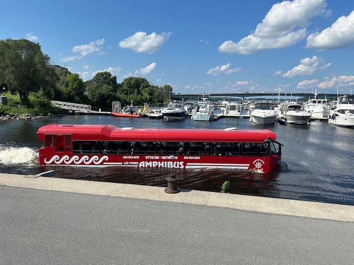 An 'amphibus' departs from the docks at a marina.