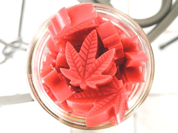 Cannabis leaf-shaped candies in a jar.