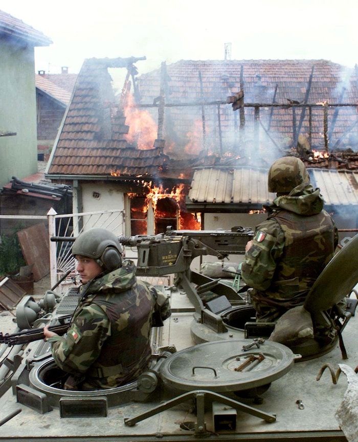 Des soldats en tenue de camouflage dans un char d'assaut.