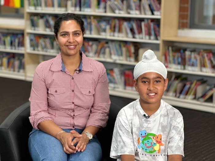 A woman and her son in a school library.