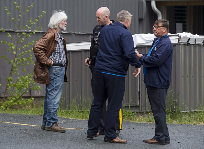 Felix Cacchione, left, director Nova Scotia's Serious Incident Response Team, along with two of his staff, right, talks with an RCMP officer at a shooting which left one person dead in Dartmouth, N.S., on Saturday, May 26, 2018. SIRT investigates all serious incidents involving police. THE CANADIAN PRESS/Andrew Vaughan