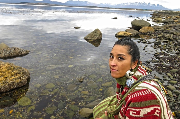 Une personne assise près d'une rivière.
