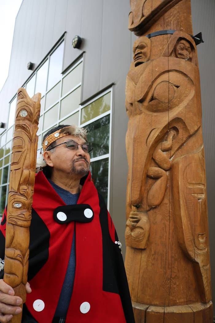 Sim’oogit Ni’isjoohl (Chief Earl Stephens) stands next to a replica of the Ni'isjoohl memorial pole in the Nisga'a Village of Laxgalts’ap, in northwestern B.C.