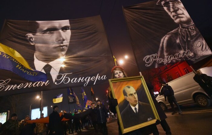 People hold flags picturing Ukrainian politician Stepan Bandera (L), one of the leaders of Ukrainian national movement and leader of the Organisation of Ukrainian Nationalists (OUN) and his ally Roman Shukhevych (R) during a march in Kiev on January 1, 2017, to mark the 108th anniversary of the birth of the Ukrainian politician. (Genya Savilov/AFP/Getty Images)