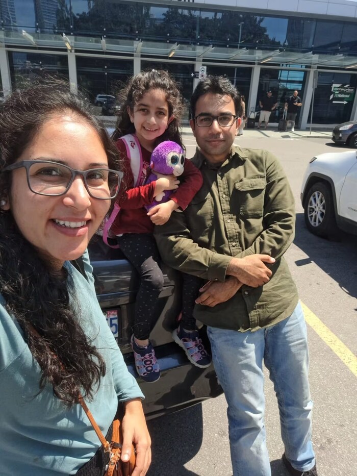 Qasim, left, with her daughter and husband outside of the Billy Bishop airport in downtown Toronto in July 2022. She regularly commutes between New Jersey and Toronto. (Submitted by Syeda Qasim)