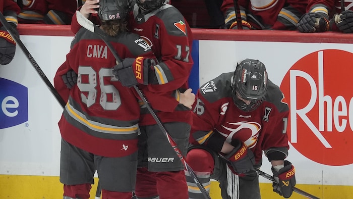 Des joueuses de hockey se font des câlins après avoir perdu un match de championnat.