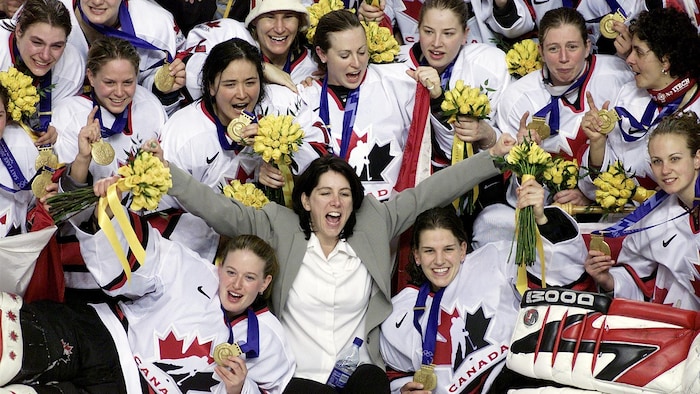Au centre de la patinoire, entourée de ses joueuses qui tiennent des bouquets de fleurs, elle hurle de joie. 