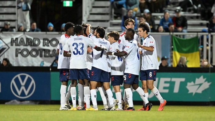 Des joueurs de soccer célèbrent leur victoire.