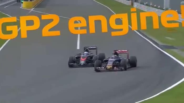 Two F1 cars, next to each other, negotiate a right turn.  