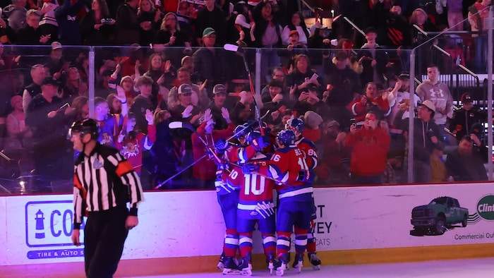 Joueurs se réjouissent devant des spectateurs.