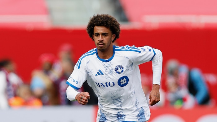 Un joueur de soccer court vers l'avant.