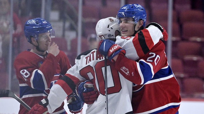 Des joueurs de hockey s'enlacent.