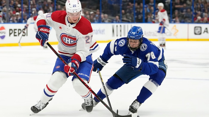 Deux joueurs se battent pour la rondelle.